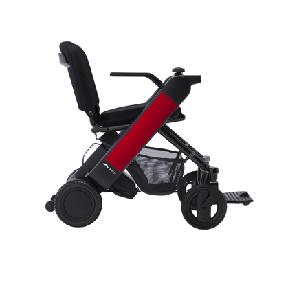 A side view of the Whill Model F Lightweight Portable Electric Wheelchair, featuring a red frame, black seat and wheels, mesh basket beneath, with downloadable specs and warranty details available.