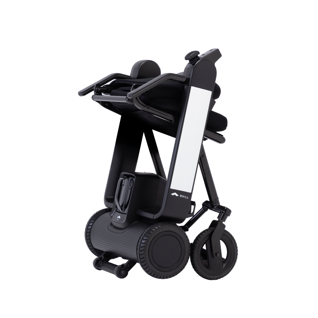 The Whill Model F Lightweight Portable Electric Wheelchair is shown folded upright for storage or transport, featuring large rear wheels, a sturdy frame, a sleek black-and-white design, and easy-to-reference specifications.