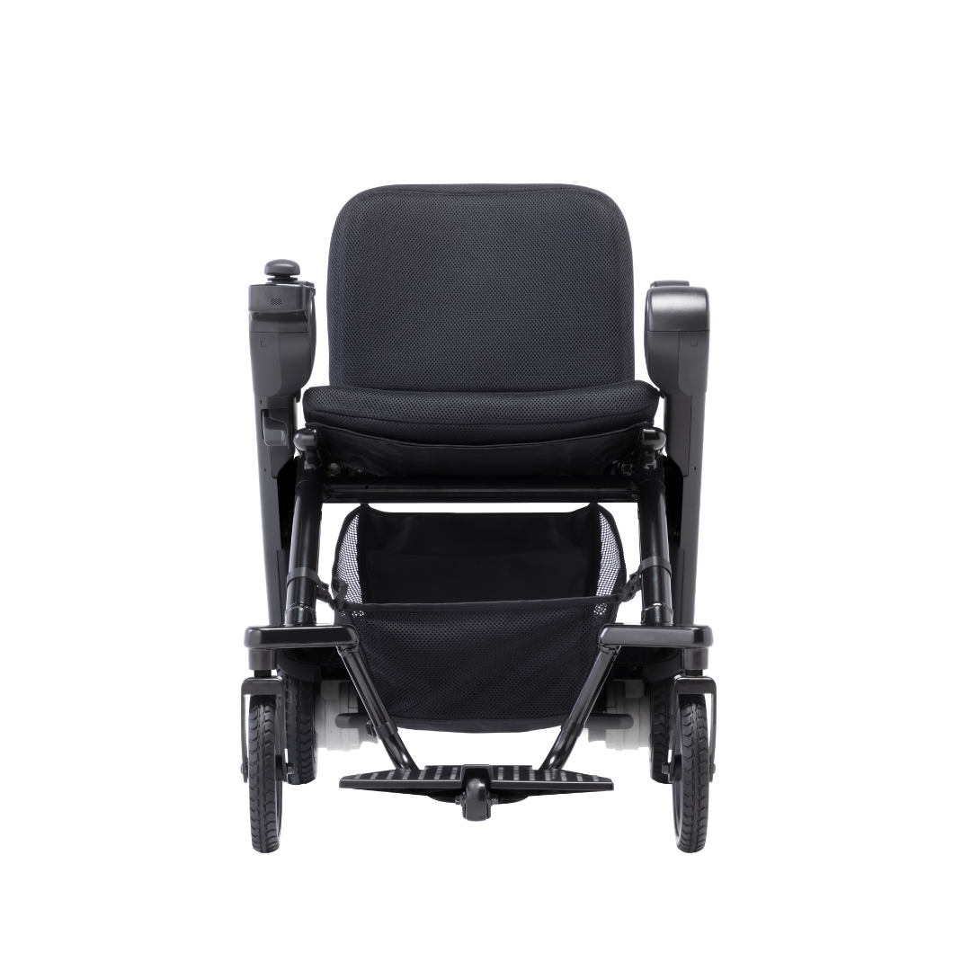 The Whill Model F Lightweight Portable Electric Wheelchair, shown from the front, is modern and black with armrests, a footrest, mesh storage under the seat, and four wheels. Detailed specifications are available for reference.