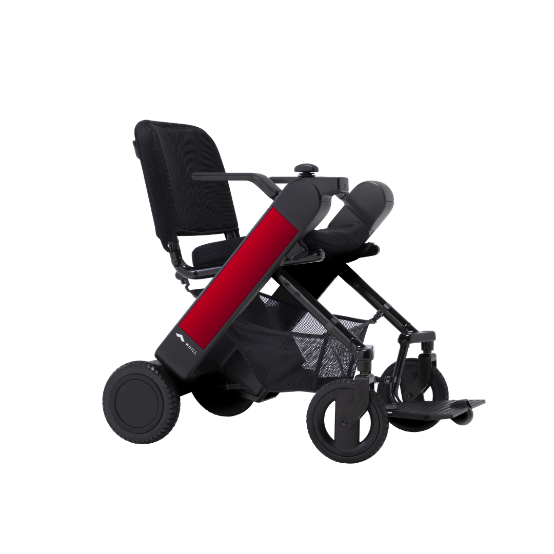 The Whill Model F Lightweight Portable Electric Wheelchair features a modern black frame with red side panels, large rear wheels, mesh storage basket, and a compact foldable design. See specifications for warranty details.