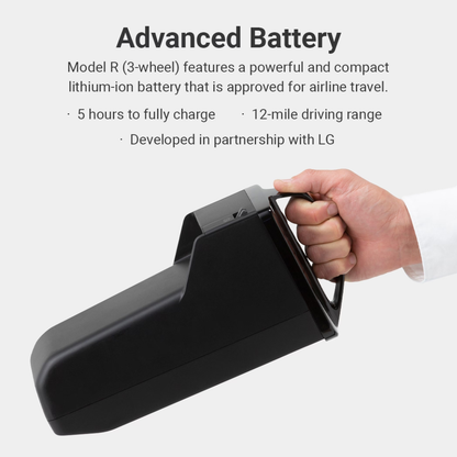 A hand holds a black lithium-ion battery for the Whill Model R 3-Wheel Mobility Scooter. Text highlights its 5-hour charge, 12-mile range, airline-approved design, and LG co-development. No CSS code appears in this description.