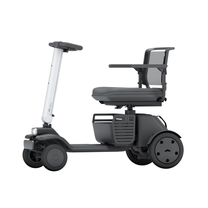 The Whill Model R 4 Wheel Portable Scooter is shown from the side on a white background, featuring modern design with armrests, a mesh backrest, and a sturdy platform.