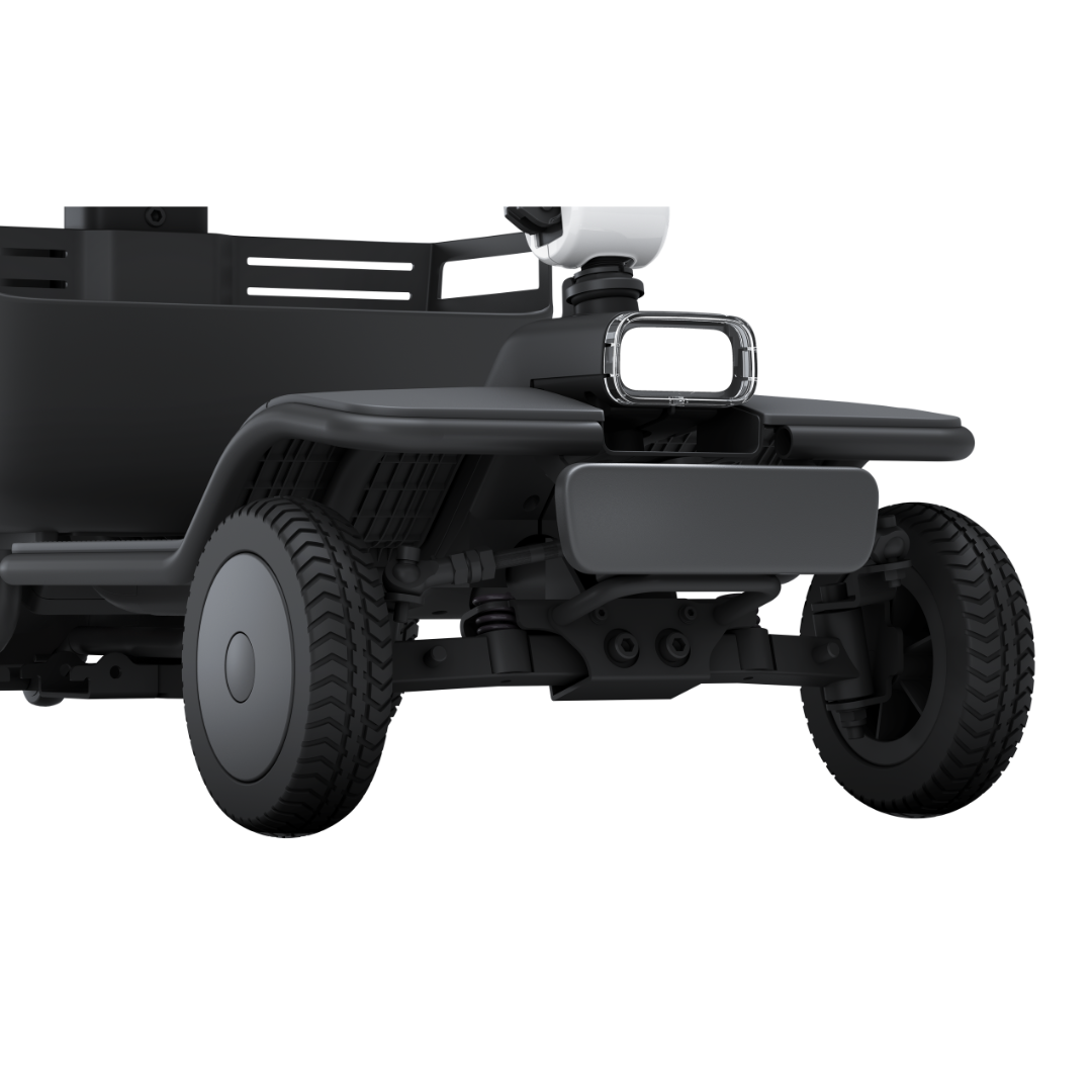 Close-up of the front wheel section of the Whill Model R 4 Wheel Portable Scooter, showcasing its durable wheels, advanced suspension, and part of the steering system for superior comfort and performance.