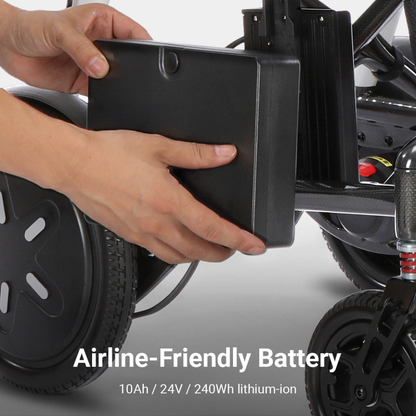 Close-up of hands inserting a rectangular black battery into a slot on a mobility device, with wheels visible. Text reads: Airline-Friendly Battery 10Ah / 24V / 240Wh lithium-ion. Perfect for the Whill MODO Breeze Ultra-Lightweight CF Folding Electric Wheelchair—this foldable powerchair offers travel-ready convenience and reliable energy for your journeys.