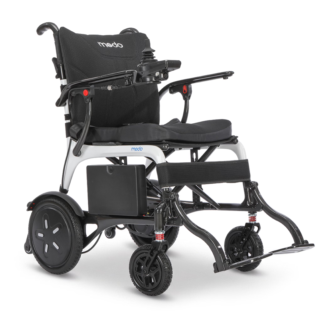 A Whill MODO Breeze Ultra-Lightweight CF Folding Electric Wheelchair in black and white, featuring a joystick control on the armrest, large rear wheels, small front wheels, and a padded seat and backrest.