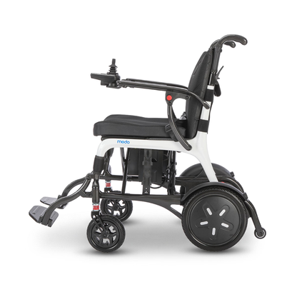 The Whill MODO Breeze Ultra-Lightweight CF Folding Electric Wheelchair, featuring joystick control, footrests, and large rear wheels, is shown in a side profile against a white background.