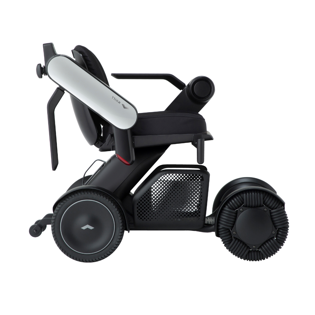 The Whill Model C2 Smart Power Chair is a compact, portable mobility device in sleek black and white, featuring large rear wheels, mesh side panel, ergonomic armrests, and FDA-compliant Class II safety. Shown in profile on a white background.