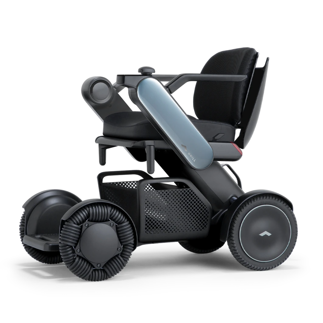The Whill Model C2 Smart Power Chair - Compact Portable Mobility features a sleek black cushioned seat, armrests, and multi-directional wheels, shown from the side on a white background. FDA Class II medical device for safety.
