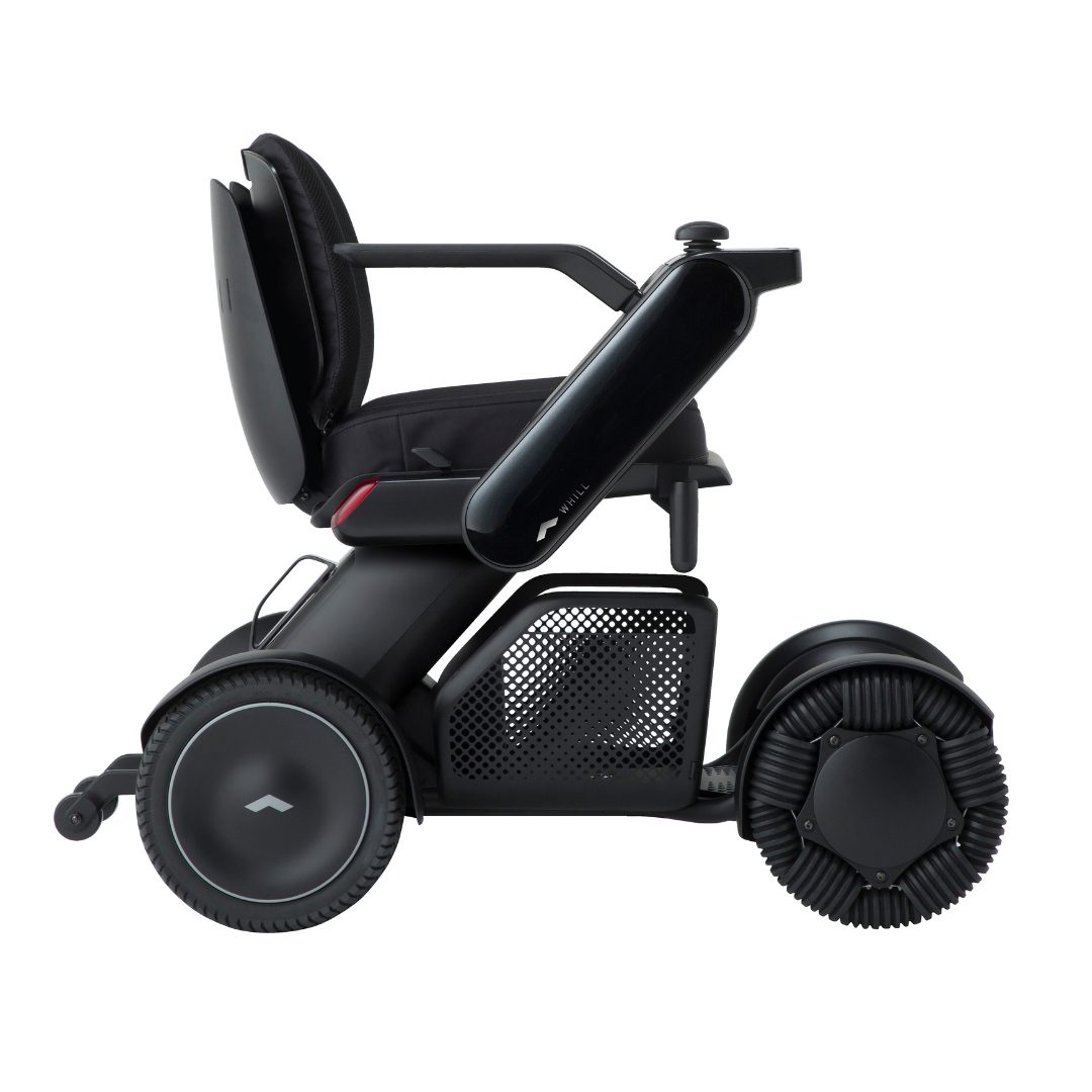The Whill Model C2 Smart Power Chair—Compact Portable Mobility—is a sleek, modern black electric wheelchair featuring large, distinct wheels and a comfy seat; shown side profile on white, this Class II medical device offers style and safety.
