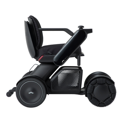 The Whill Model C2 Smart Power Chair—Compact Portable Mobility—is a sleek, modern black electric wheelchair featuring large, distinct wheels and a comfy seat; shown side profile on white, this Class II medical device offers style and safety.