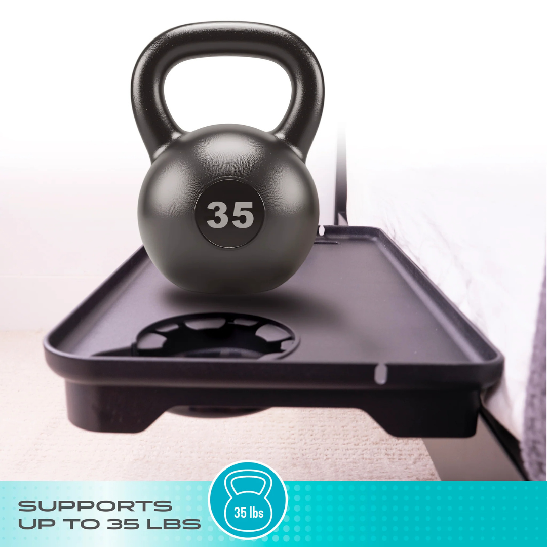 A 35-pound black kettlebell rests on the Stander Wonder Bedside Shelf Tray, a space-saving bedroom solution. Text below reads, “SUPPORTS UP TO 35 LBS,” next to a kettlebell icon labeled “35 lbs.”.