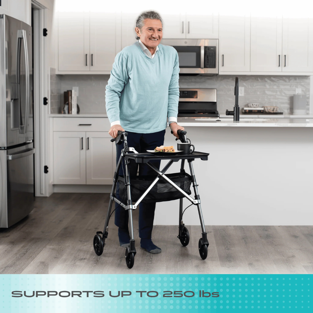 A gray-haired older adult smiles while using the Stander Wonder Indoor Rollator with Tray Table in a bright, modern kitchen. Text at the bottom reads: SUPPORTS UP TO 250 lbs.
