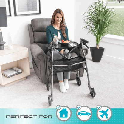 A woman relaxes in a recliner, happily using the Stander Wonder Indoor Rollator with Tray Table to hold her meal. Icons highlight that this rollator is perfect for use at home, in the car, and on airplanes.