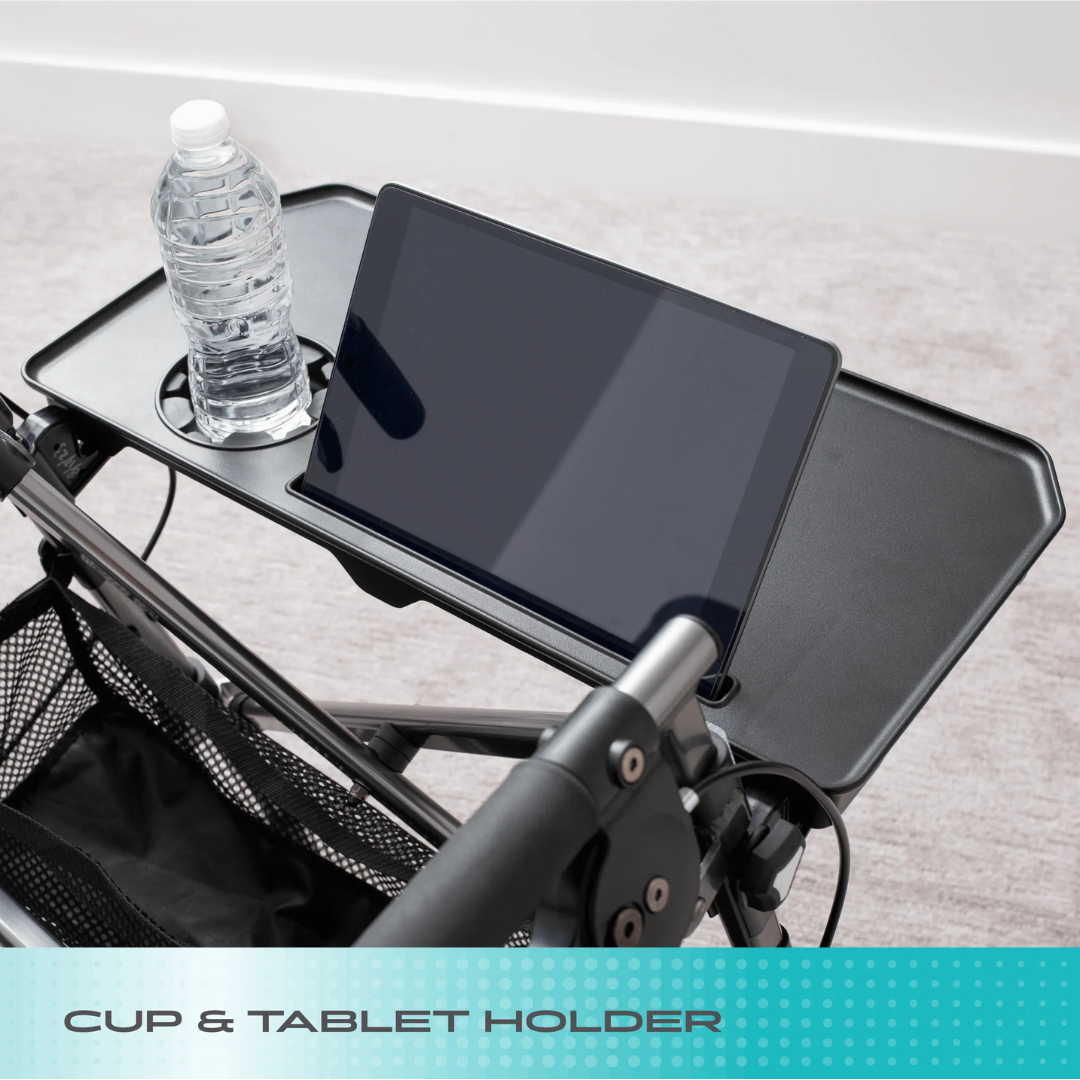 A black cup and tablet holder attached to a stroller holds a water bottle and tablet—like the convenient accessories on the Stander Wonder Indoor Rollator with Tray Table. Text at the bottom reads “CUP & TABLET HOLDER.”.