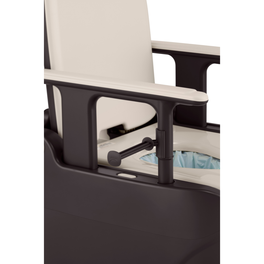 A close-up of a black and white commode chair with armrests, featuring a seat opening lined with a disposable blue bag, like those used in the Wrappon® ORB Portable Commode Toilet with Auto Waste Sealing.