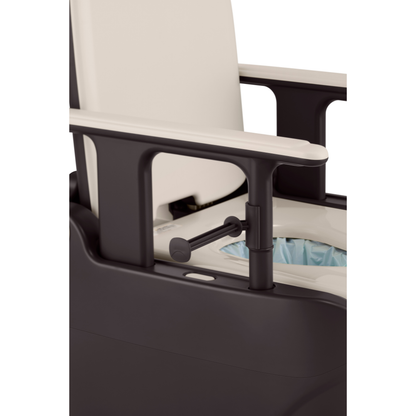 A close-up of a black and white commode chair with armrests, featuring a seat opening lined with a disposable blue bag, like those used in the Wrappon® ORB Portable Commode Toilet with Auto Waste Sealing.