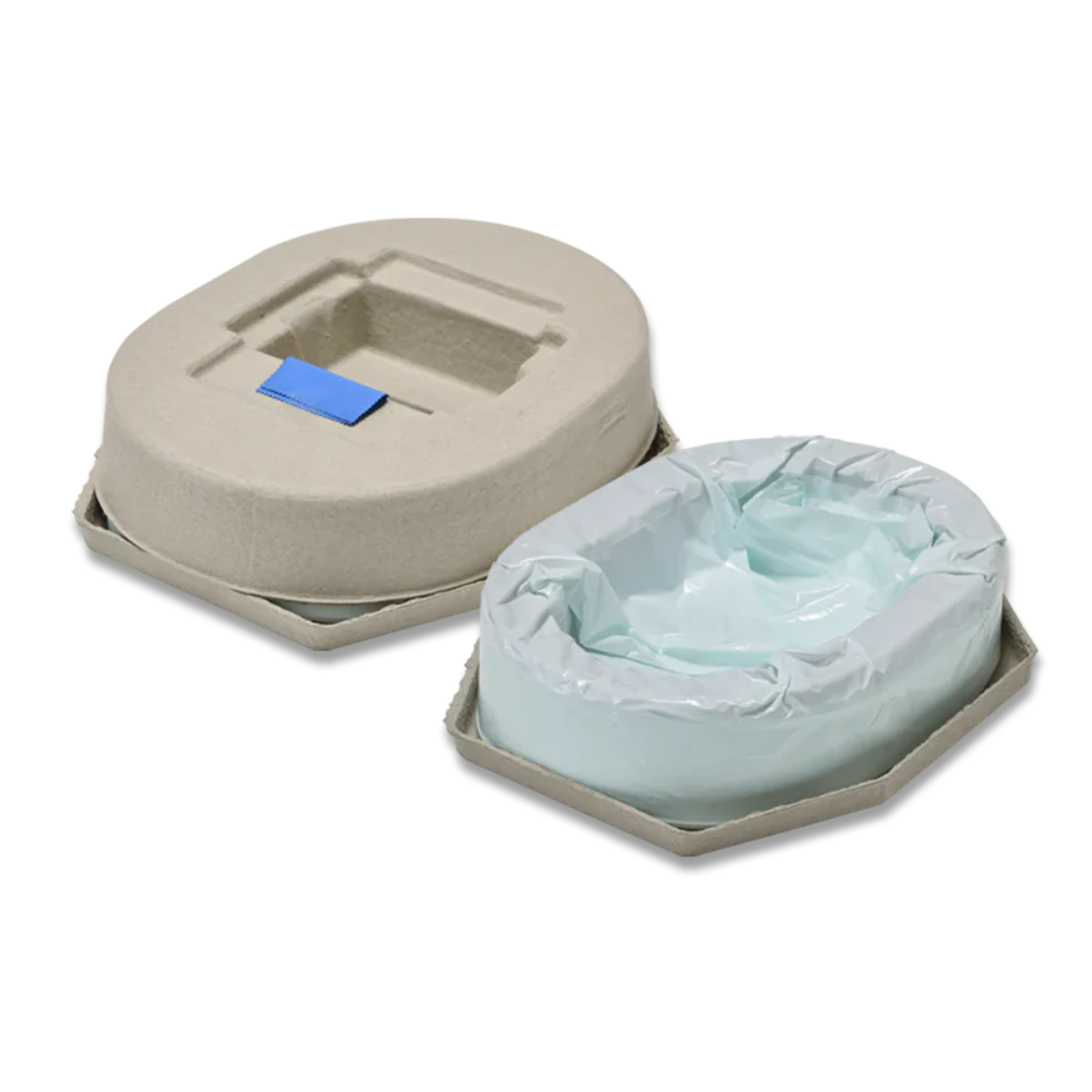 Two disposable bedpans compatible with the Wrappon® ORB Portable Commode Toilet are shown; one has a blue tab cover, while the other is open to display a plastic liner. Both are made of beige, cardboard-like material.