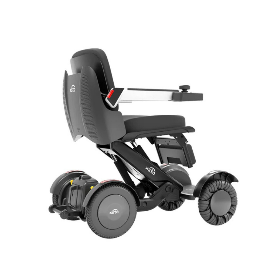 The XSTO M4 Mobility Robot Powerchair is a modern, lightweight foldable wheelchair in sleek black with padded seat, armrests, and four large wheels. Shown from the side on white background—ideal for travel and daily mobility.