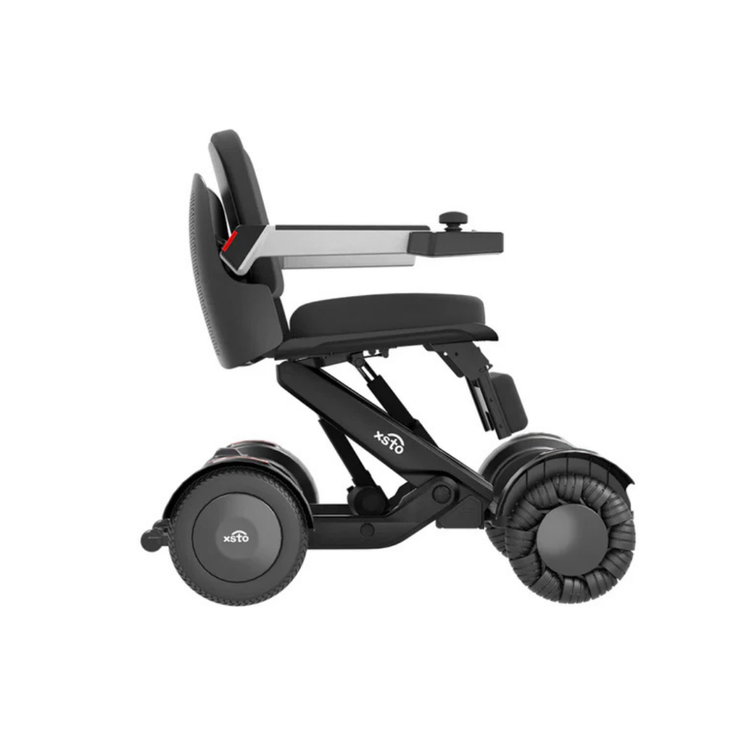 The XSTO M4 Mobility Robot Powerchair is a modern black, lightweight, foldable wheelchair with a padded seat, armrests, right-arm joystick control, and large rear wheels for enhanced senior mobility.