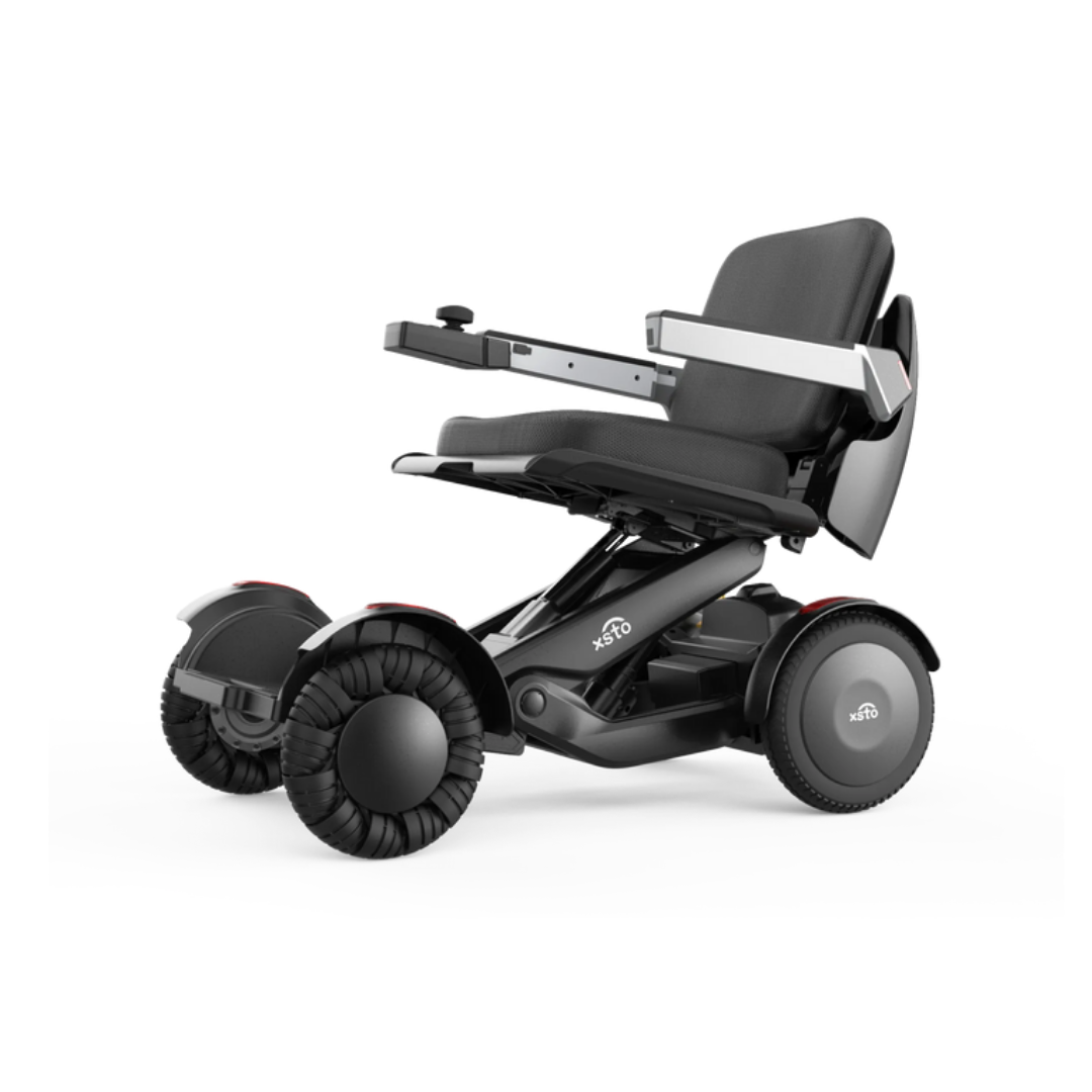 The XSTO Mobility M4 Self-Balancing Powerchair is a modern, compact travel electric wheelchair featuring four large wheels, a black cushioned seat, and an armrest control panel for enhanced mobility and sleek style.