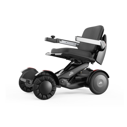 The XSTO Mobility M4 Self-Balancing Powerchair is a modern, compact travel electric wheelchair featuring four large wheels, a black cushioned seat, and an armrest control panel for enhanced mobility and sleek style.