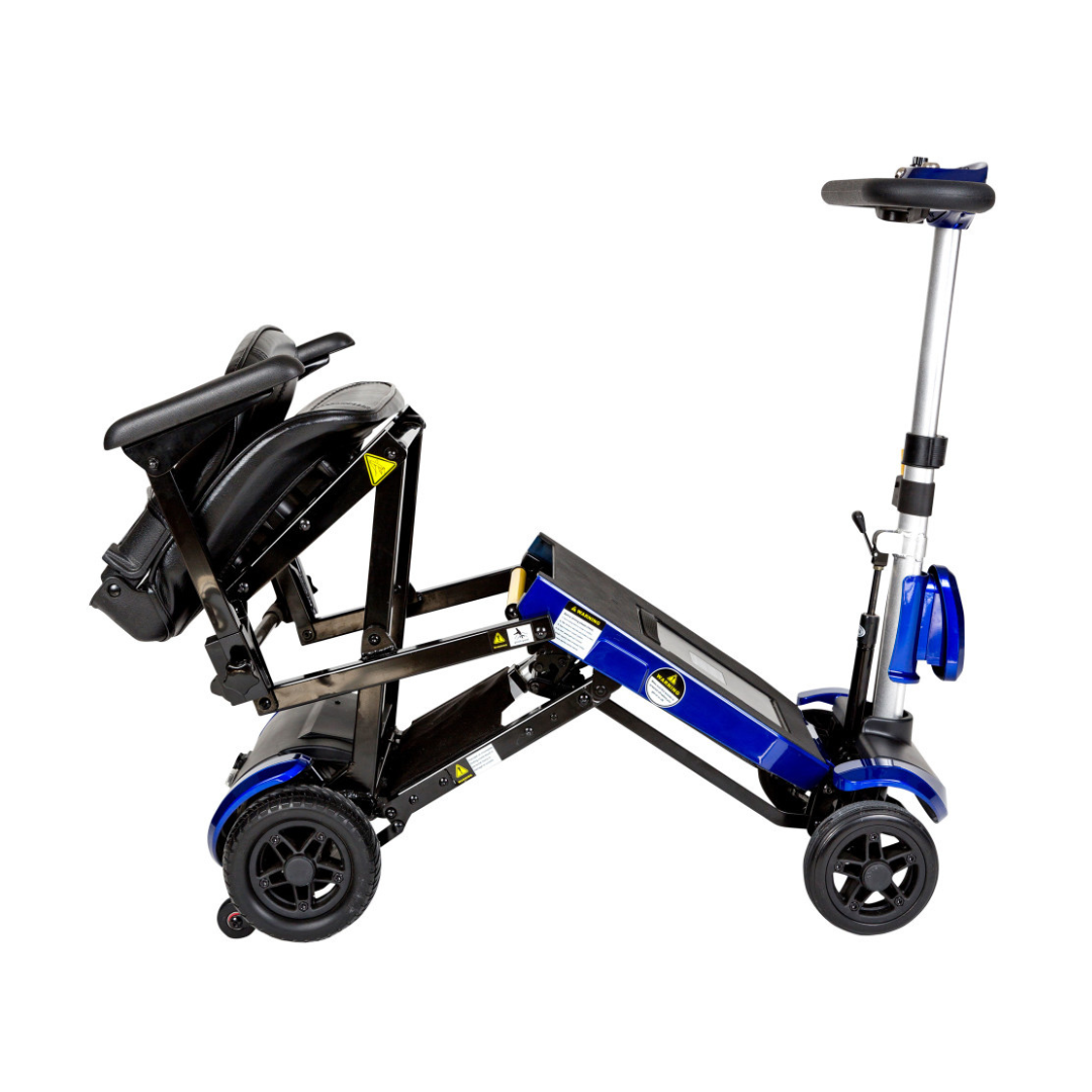 The Drive ZooMe Auto-Flex Folding Travel Scooter, in blue and black, is shown partially folded with its seat, handlebars, and four wheels visible against a white background.