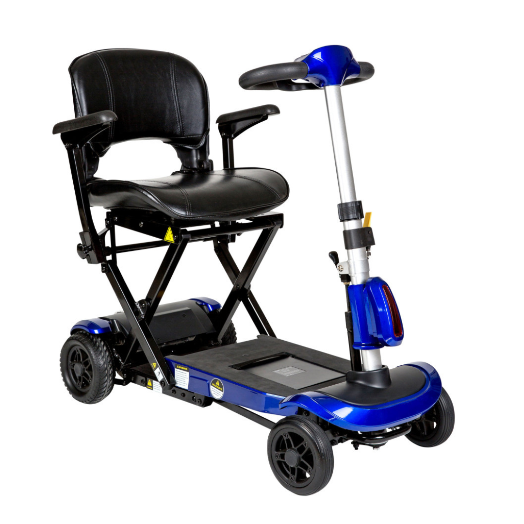 The Drive ZooMe Auto-Flex Folding Travel Scooter is a compact, auto-folding mobility scooter with a blue frame, padded black seat, armrests, four small wheels, handlebar controls, and a foldable foot platform.