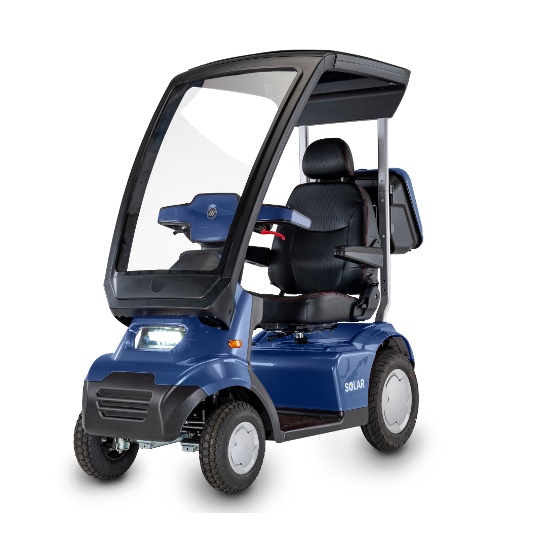 The Afikim Afiscooter Solar is a solar-powered bariatric mobility scooter featuring a transparent canopy, solar panel for efficient charging, ergonomic tiller, black seat with armrests, control panel, four wheels, and a small front light. It combines sleek modern design with functionality.