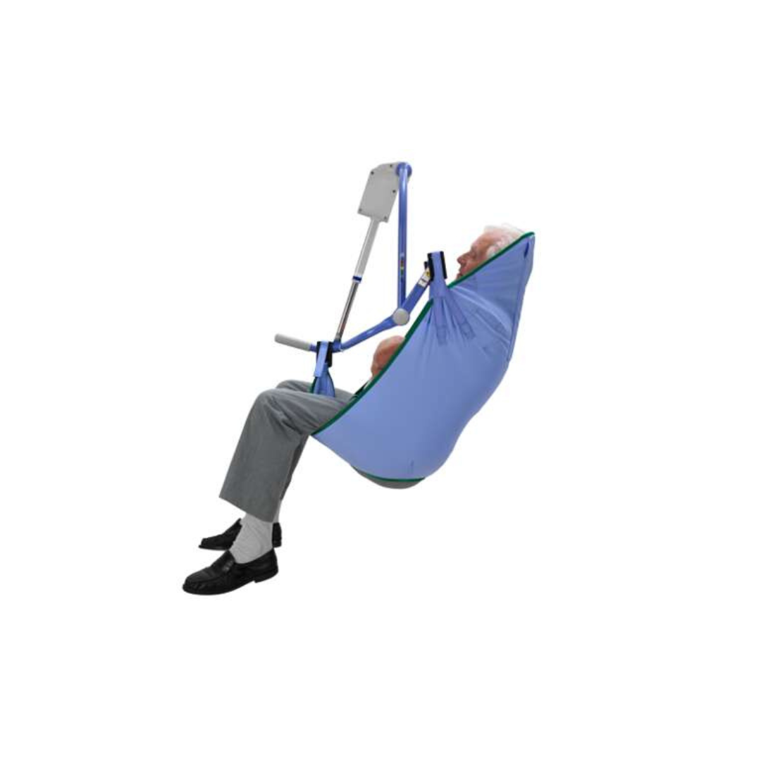 An elderly person is seated in an ARJO 4-Point Spreader Sling for patient lifts, connected to a mechanical floor lift. They wear gray pants, black shoes, and white socks, all set against a plain white background.