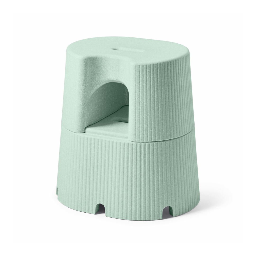The byACRE DORICA is a light green, stackable step stool and seat with ribbed sides, a top handle, semi-circular under-seat cutout, and features water resistance and an anti-slip design.