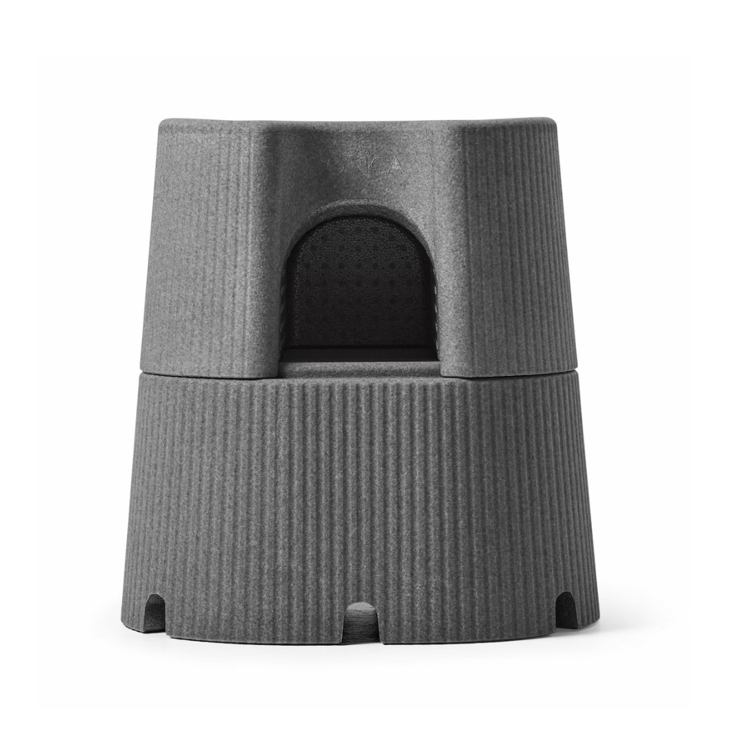 The byACRE DORICA Versatile Step Stool & Seat is a gray, cylindrical, stackable stool with a ridged lower half and arched cutout—water-resistant, anti-slip, and perfect for use as both a step and convenient seat.