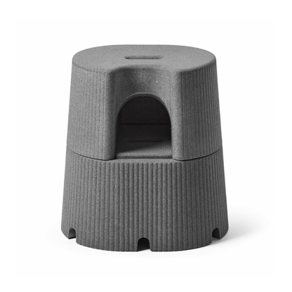 The byACRE DORICA – Versatile Step Stool & Seat is a modern gray, cylindrical design with a built-in handle, ribbed sides, and an arched middle compartment for storage. Water-resistant and anti-slip for reliable use as seat or footrest.