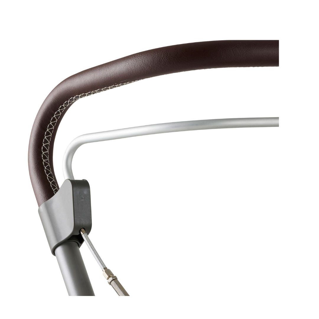 Close-up of the byACRE Scandinavian Butler At-Home Rollator handle, featuring a brown leatherette cover with white stitching and a sleek silver metal frame against a white background.