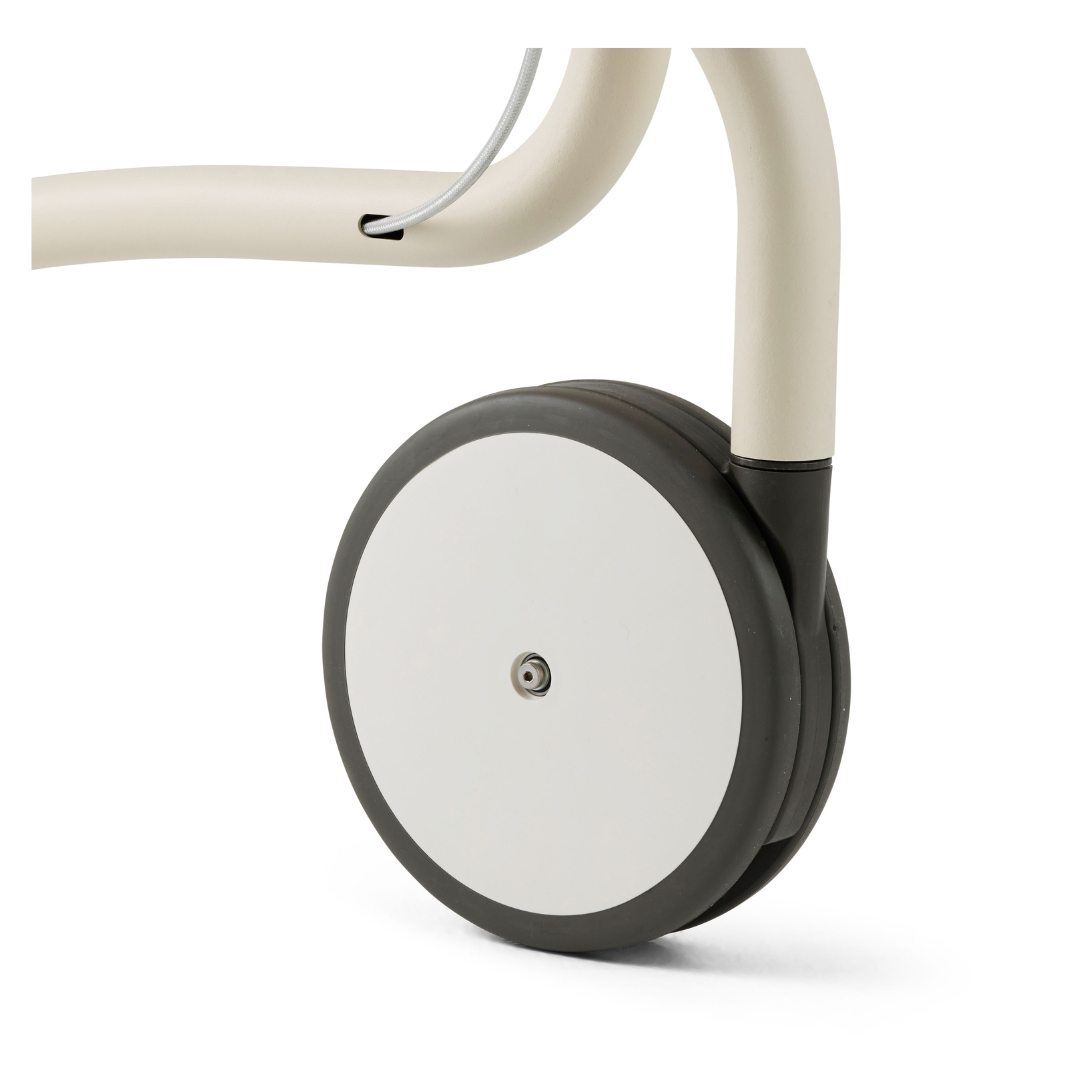 Close-up of a modern round caster wheel attached to the byACRE Scandinavian Butler At-Home Rollator’s light metal frame, featuring minimalist design and a sleek cable along the frame.