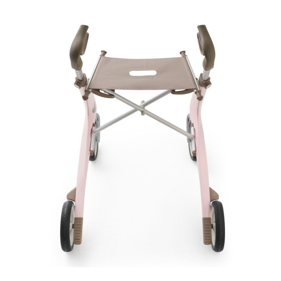 A front view of the ByACRE Ultralight Carbon Fiber Rollator (10.6 lbs) in pink and brown, featuring a fabric seat, angled handles, and sturdy frame, designed to assist with mobility.