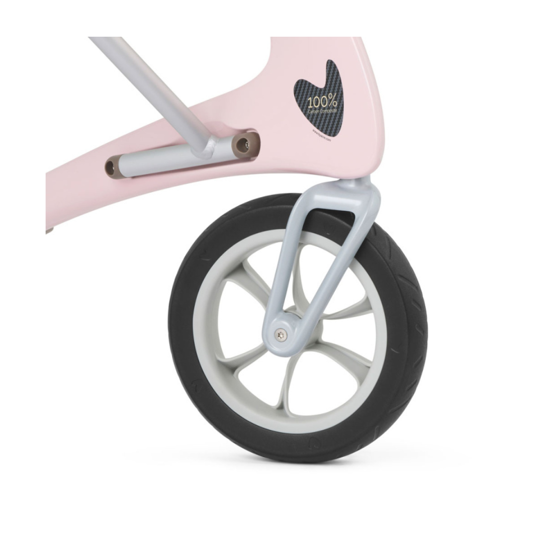 Close-up of a black rubber wheel with a gray rim on the ByACRE Ultralight Carbon Fiber Rollator (10.6 lbs), attached to its light pink frame and featuring a heart-shaped cutout marked “100%” inside.