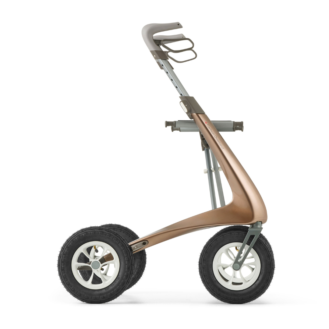 The ByACRE Carbon Overland All-Terrain Rollator features a modern, minimalist design with large black rubber tires, a bronze curved frame, and a top handlebar—perfect for carrying items or equipment on any adventure.
