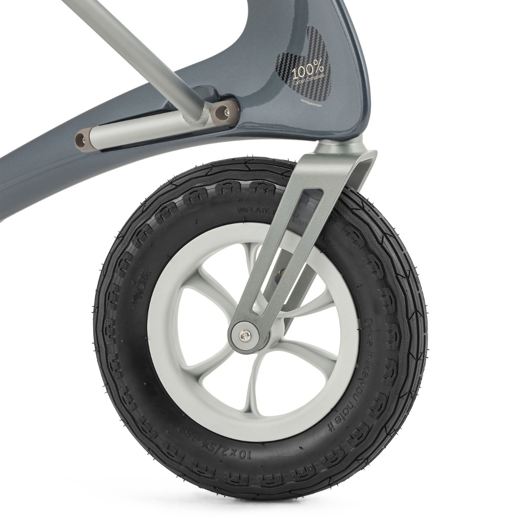 Close-up of the ByACRE Carbon Overland All-Terrain Rollator’s rugged front wheel, featuring a black treaded tire, silver spokes, and part of the sturdy frame with “100%” printed in white.