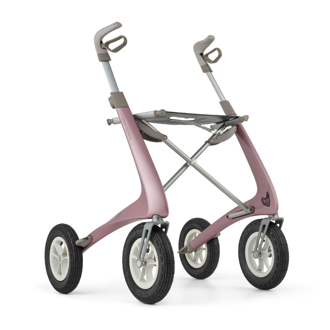 The ByACRE Carbon Overland All-Terrain Rollator is a modern, minimalist walker in pink and gray, with four large black rubber wheels and two curved handles—designed for stability, support, and adventurous worry-free exploration.
