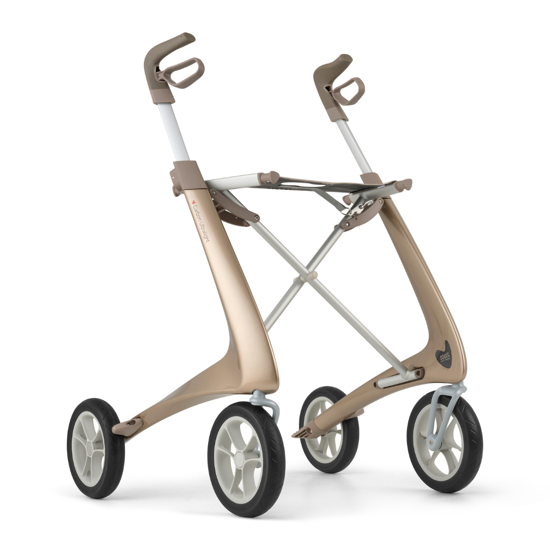 The ByACRE Ultralight Carbon Fiber Rollator (10.6 lbs) is a modern, minimalist mobility aid featuring four large wheels, a metallic gold frame, ergonomic handles, and no visible seat or basket.