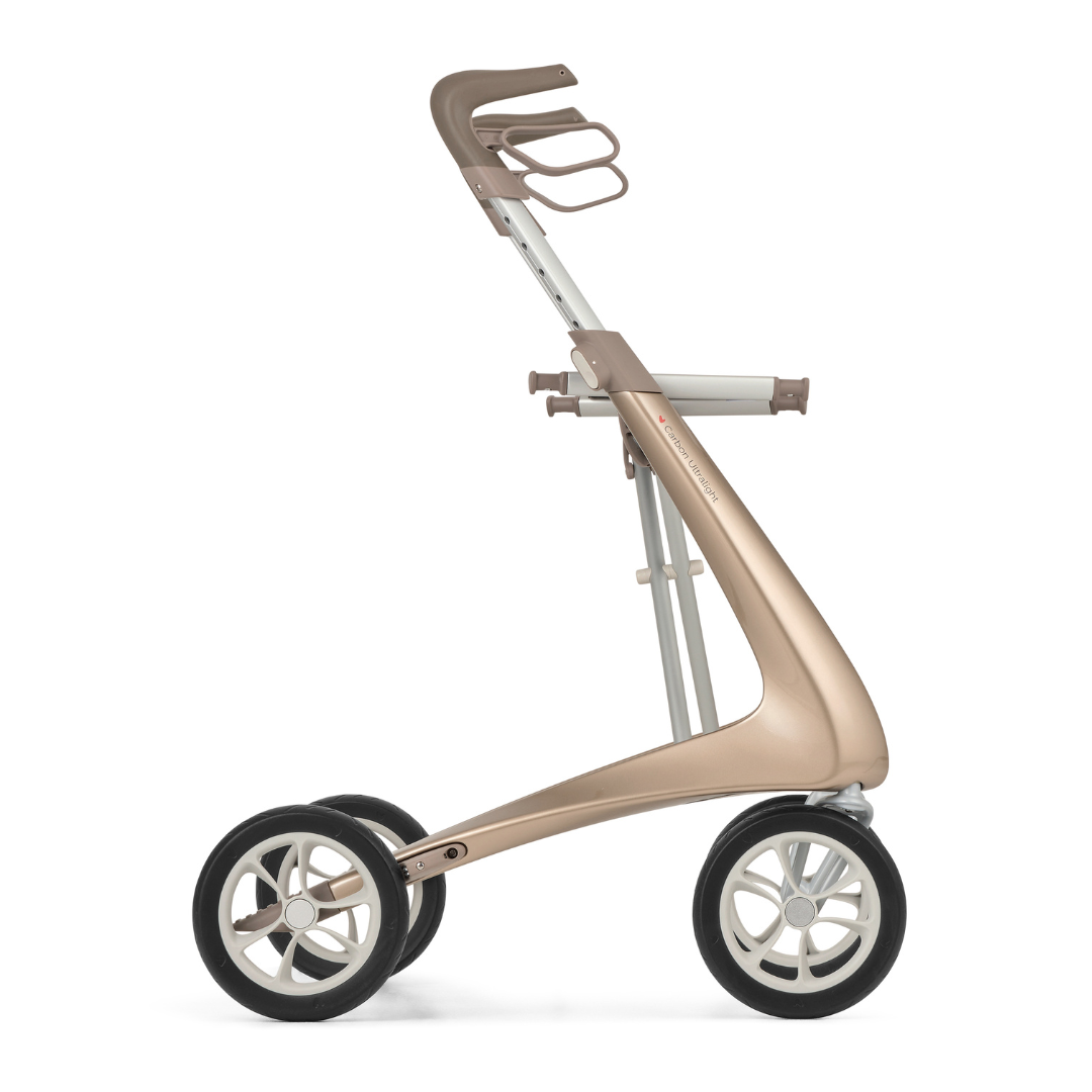 The ByACRE Ultralight Carbon Fiber Rollator (10.6 lbs) features a sleek metallic gold frame, ergonomic handle, and four large black-and-white wheels, shown in profile against a white background.