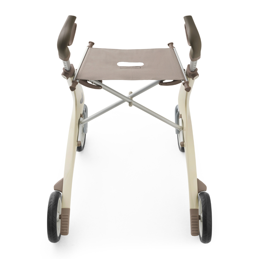 The ByACRE Ultralight Carbon Fiber Rollator (10.6 lbs) in beige and brown, featuring a fabric seat and armrests, is shown from above against a white background.