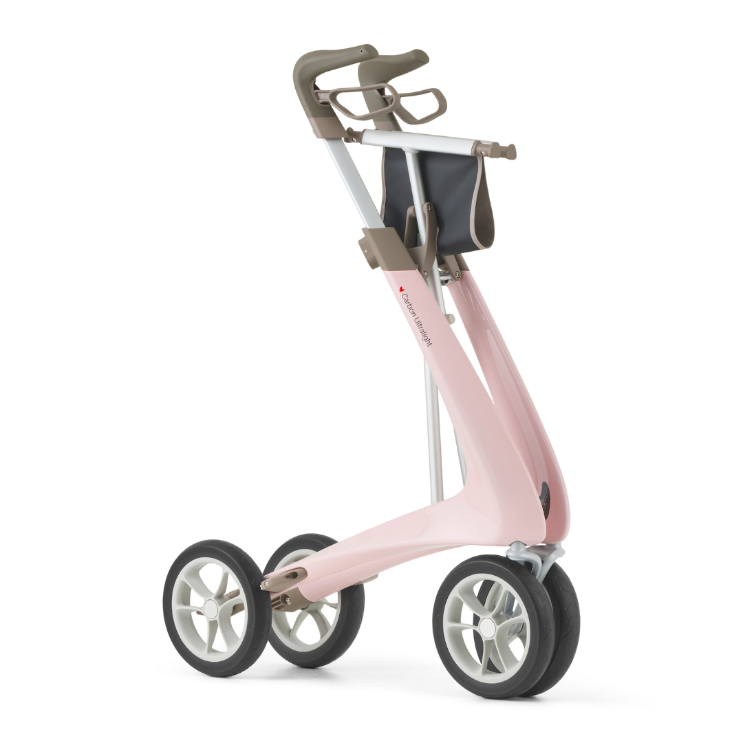 The ByACRE Ultralight Carbon Fiber Rollator (10.6 lbs) is a modern, pink mobility aid with grey handles, a seat, compact storage pouch, and large black-and-white wheels for easy maneuvering.