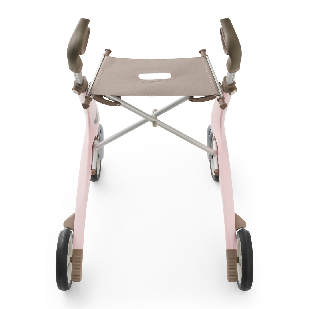 The ByACRE Ultralight Carbon Fiber Rollator (10.6 lbs) in pink and brown, featuring armrests and a fabric seat, is shown from above on a white background.