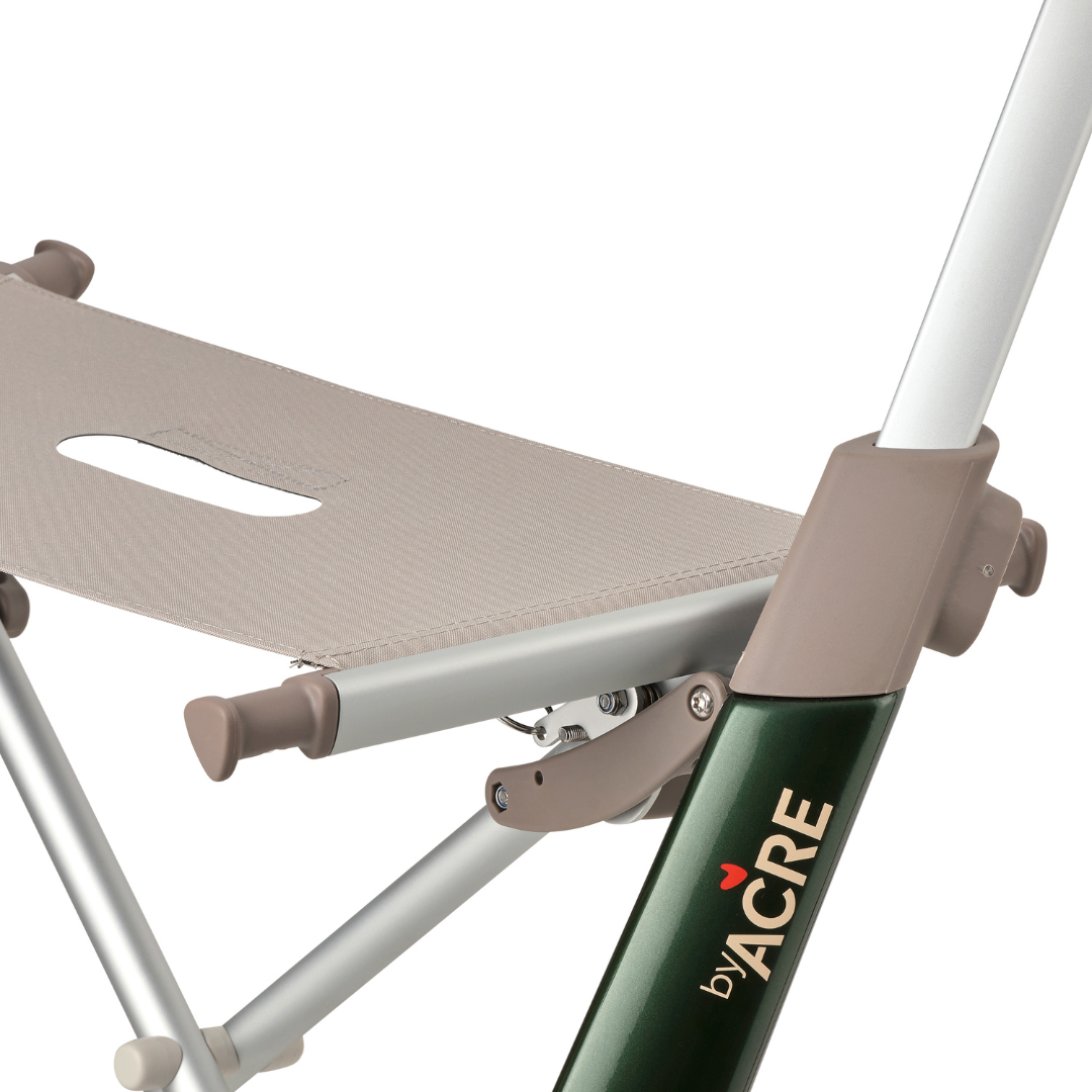 Close-up of the ByACRE Ultralight Carbon Fiber Rollator (10.6 lbs) showing a beige seat, silver frame, and green byACRE label with a red heart. Its modern minimalist design makes it a stylish and lightweight mobility aid.