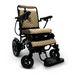 The ComfyGo MAJESTIC IQ-8000 is a travel-friendly, lightweight electric wheelchair in beige and black, featuring quilted upholstery and joystick control on the armrest. It boasts a diamond-patterned seat and backrest with a black footrest, proudly displaying the Majestic brand name on the backrest.