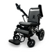 The ComfyGo MAJESTIC IQ-8000 is a remote-controlled, lightweight electric wheelchair featuring a stylish black and gray design with quilted seat and backrest. It includes adjustable armrests, a footrest, sturdy wheels, and a control panel conveniently located on the left armrest. The travel-friendly Majestic brand logo is prominently displayed on both the frame and seat.