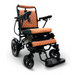 Introducing the ComfyGo MAJESTIC IQ-8000—a chic and portable electric wheelchair boasting a lightweight black frame with a plush brown seat and backrest. Designed for user comfort and mobility, it comes equipped with armrests, a joystick control on one side, and four robust wheels.