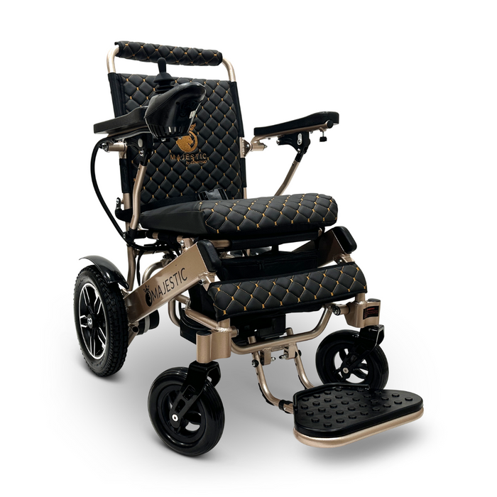 The ComfyGo MAJESTIC IQ-8000 is a luxurious, lightweight electric wheelchair adorned with a black and gold quilted design. It features cushioned armrests, large rear wheels, and joystick control for ease of use. This travel-friendly and stylish model proudly displays the Majestic brand name on both the backrest and side frame.