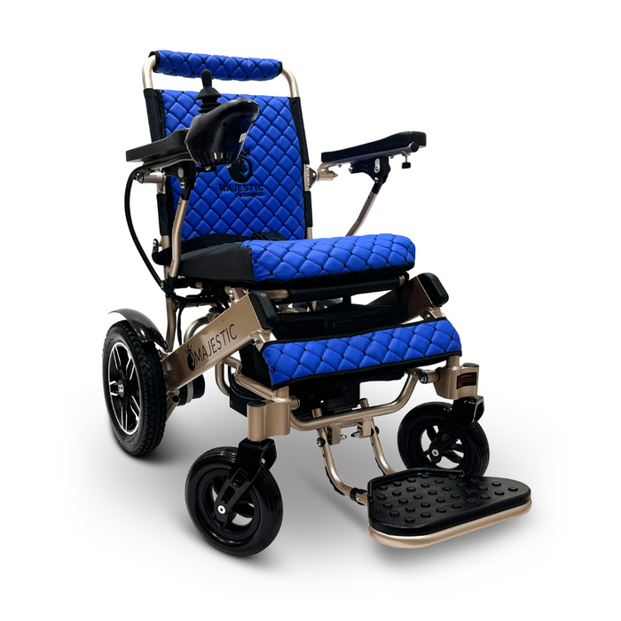 The ComfyGo MAJESTIC IQ-8000 Remote Controlled Lightweight Electric Wheelchair features a sleek, travel-friendly design with quilted blue seat cushions, padded armrests, and an adjustable footrest. Its lightweight frame includes a black control joystick mounted on the right armrest and four wheels for easy mobility.